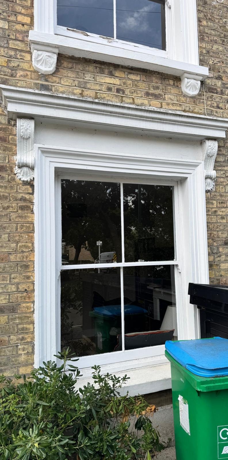 Project 01, before: Sash window with peeling paint on the sill before decorating