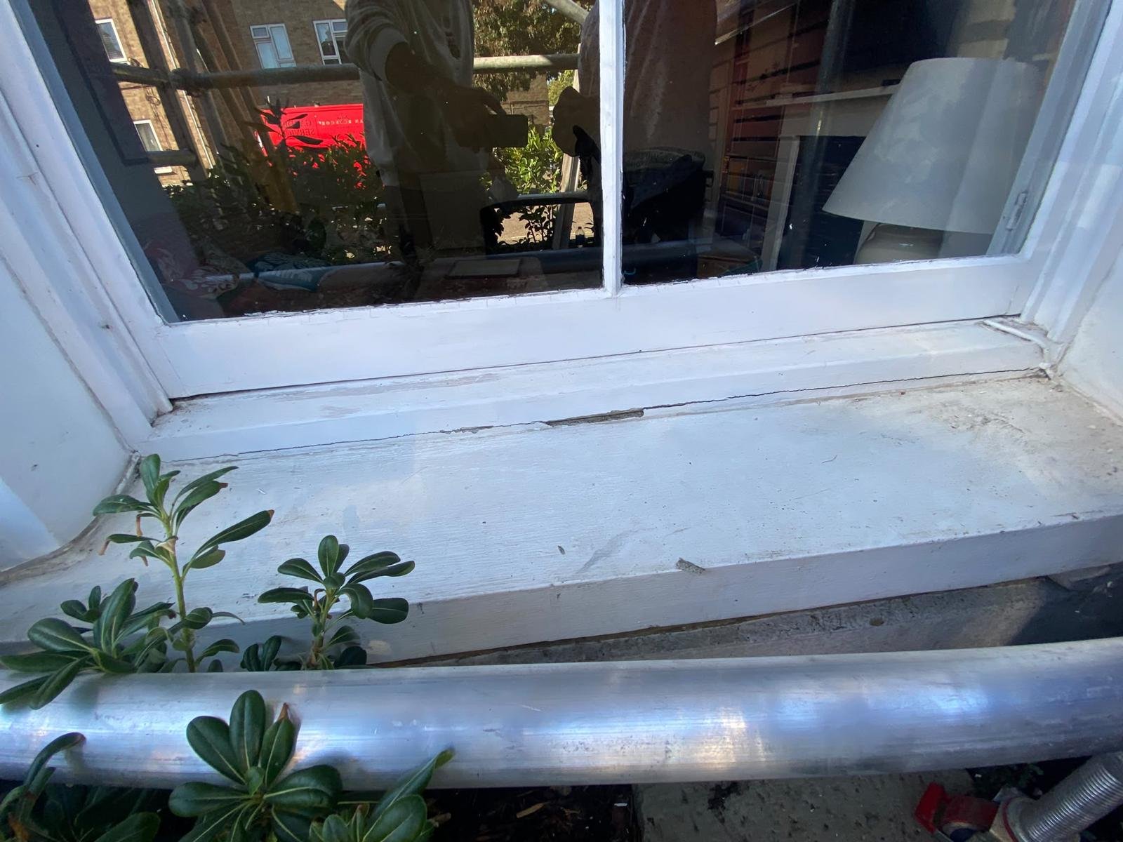 Project 02, before: Close-up of a wooden window sill and frame during preparation